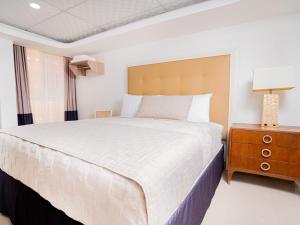 Postel nebo postele na pokoji v ubytování Muna Hotel