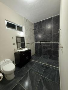 a bathroom with a toilet and a sink at Villa los Encinos 