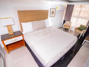 Postel nebo postele na pokoji v ubytování Muna Hotel