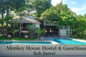 a house and a swimming pool in front of a house at Monkey House Hostel & Guest House Koh Samui in Chaweng Noi Beach