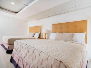 Postel nebo postele na pokoji v ubytování Muna Hotel