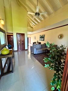 a living room with a couch and a table at Casa Pors Luxury Apartment with Security, Pool, & Gym in Liguanea