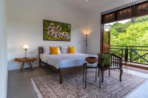 a bedroom with a bed and a balcony at Villa 6 - Private Pool WOW Holiday Homes in Pantai Cenang +30 photos