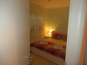 niewielka sypialnia z łóżkiem i oknem w obiekcie Apartment Simaris - spacious with terrace and sea view w Szybeniku