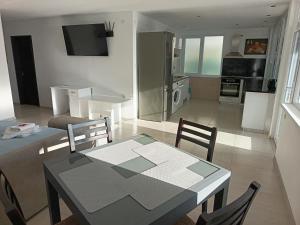 a kitchen and living room with a table and chairs at Victoria in Byala +46 photos