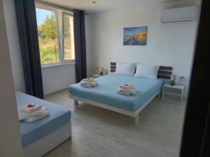 a bedroom with a bed with towels on it at Victoria in Byala
