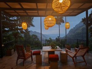 a patio with a table and chairs and lights at meditation monastery stay in Ella +184 photos