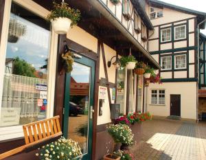 a store with a bench in front of a building at Hotel Abtshof in Halberstadt