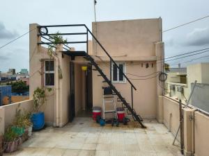 a staircase on the side of a building with a balcony at Blue Diamond in Chennai