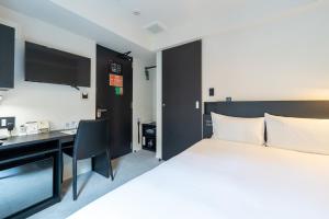 a hotel room with a bed and a desk at HOTEL TABARD TOKYO - Vacation STAY 62622v in Tokyo