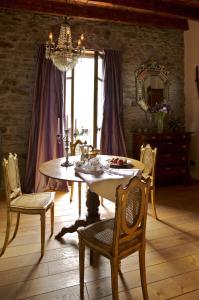 una sala da pranzo con tavolo, sedie e lampadario pendente di Via Col Tempo a Pigna