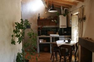 a kitchen with a table and a dining room at Via Col Tempo in Pigna
