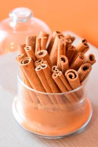 a glass container filled with cinnamon sticks on a table at Kuršu krogs in Dižstende