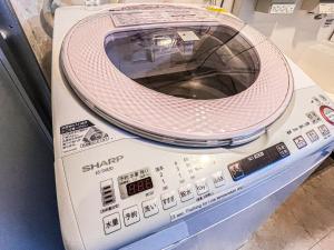 a washing machine sitting on top of a machine at Imagine Annex in Kyoto