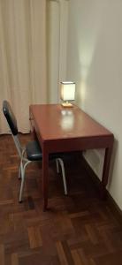 a desk with a lamp on it with a chair at Casa Estratégica in Sucre