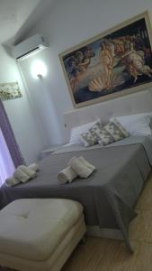 a bedroom with a large bed and a painting on the wall at Italian style Apartment in Durrës