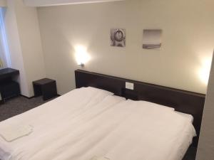Katil atau katil-katil dalam bilik di Business Hotel Sunpu