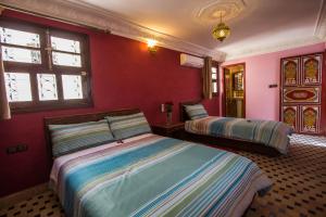 A bed or beds in a room at Dar El Mathaf