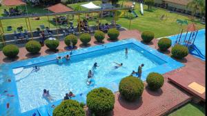 an overhead view of a swimming pool with people in it at Hotel y Cabañas Manolo in El Pedregal +32 photos