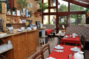 a restaurant with tables and chairs and a counter at Pension Nika in Český Krumlov