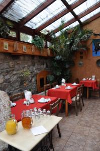 a restaurant with two tables with red tablecloths at Pension Nika in Český Krumlov +73 photos
