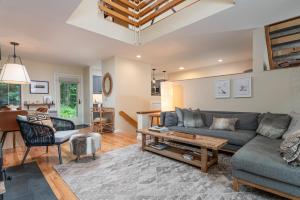 a living room with a couch and a table at Club Sugarbush #8 condo in Warren +37 photos