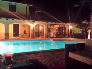 a swimming pool in a yard at night at Aquilamaior in Tragliata