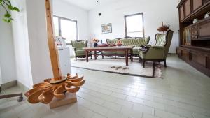 a living room with a table and chairs at Guest House Hodak in Rakovica
