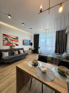 a large living room with a bed and a table at Atmosfera Sea View Apartments in Odesa +5 photos