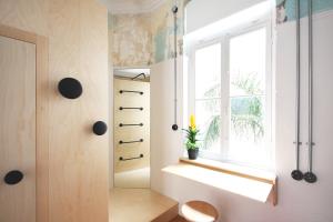 a room with a window and a plant on a shelf at The Trilogy House in Thessaloniki +41 photos