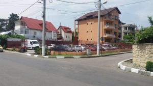 a street with cars parked in a parking lot at Hotel Roxy & Maryo- Restaurant -Terasa- Loc de joaca pentru copii -Parcare gratuita in Eforie Nord