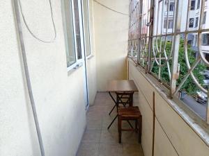 a balcony with a table and a window at Hostel Museum in Tbilisi City