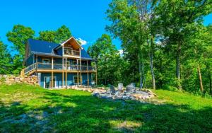 a large house on a hill with chairs in the yard at Eagles Flight in Sevierville
