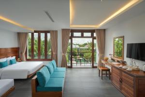 a hotel room with a bed and a television at Khmer House Resort in Siem Reap