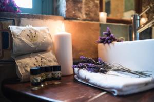 a table with a candle and some flowers on it at Palaeopoli Villas in Avlemonas