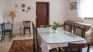 a living room with a table and a couch at Guest House Hodak in Rakovica +33 photos
