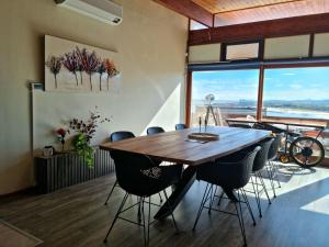 a dining room with a wooden table and chairs at 'The Loft', 2 bedroom, sleeps 4, Central, Fantastic Views! in Cape Town