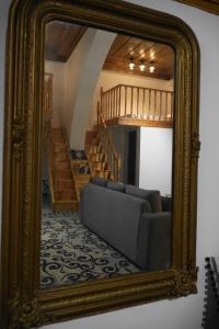 a mirror with a couch in a living room at Diolanth traditional house in Koskinou
