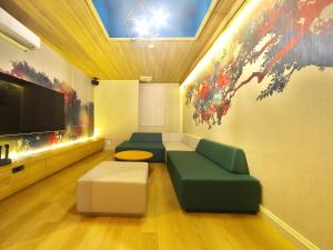 a living room with a couch and a flat screen tv at HOTEL BOTA 豊橋 -Adult Only- in Toyohashi