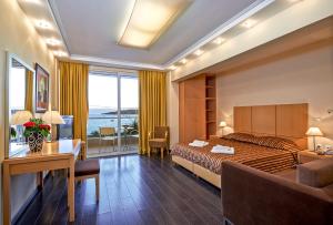 a hotel room with a bed and a desk at Nautica Bay Hotel in Porto Heli +26 photos