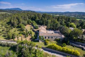 an aerial view of a large stone house with trees at Mas de Fournel in Saint-Clément-de-Rivière