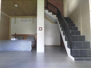 a bedroom with a staircase and a bed in a room at ARISTA Homestay in Tetebatu +45 photos