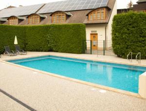 a large blue swimming pool in front of a house at Hotel Baroko in Prague +33 photos