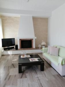 a living room with a couch and a coffee table at Euphoria Estate 2 in Agia Marina Aegina
