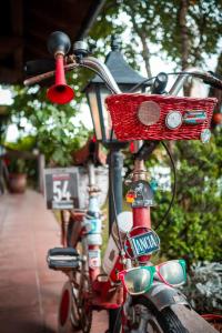 a red bike with a basket on the side of it at HOTEL La Locanda in Pinzolo +39 photos