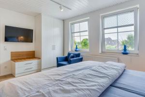 Postel nebo postele na pokoji v ubytování Lüttje Ginsterhuus - Ferienwohnung Käptn Pep