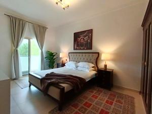 a bedroom with a large bed and a window at Luxury 3 Bedroom Villa MSQ Muscat Parkside Retreat in Muscat