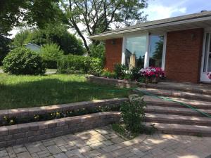 a house with a garden hose on the front yard at Mac B&B in Ottawa