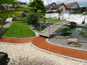 a bridge over a pond in a yard at Apartment Euro AS in Kappel-Grafenhausen