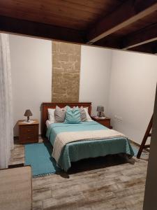 a bedroom with a bed with two night stands and two lamps at Flora's Traditional House in Malona Village